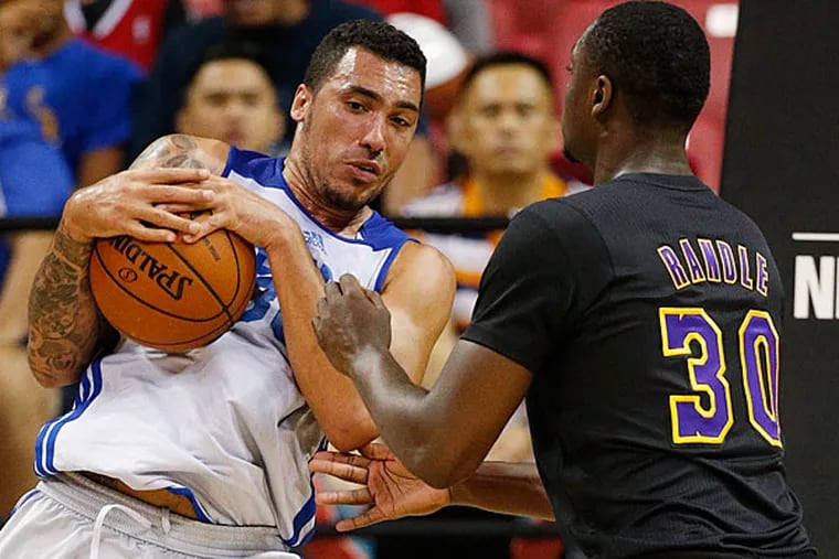 Drew Gordon grabs a rebound against Los Angeles Lakers' Julius Randle during the first half of an NBA summer league basketball game Wednesday, July 16, 2014, in Las Vegas. (John Locher/AP)