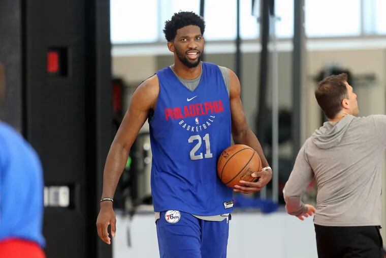 Joel Embiid carries the ball during practice at the Sixers’ training complex in Camden on Thursday.