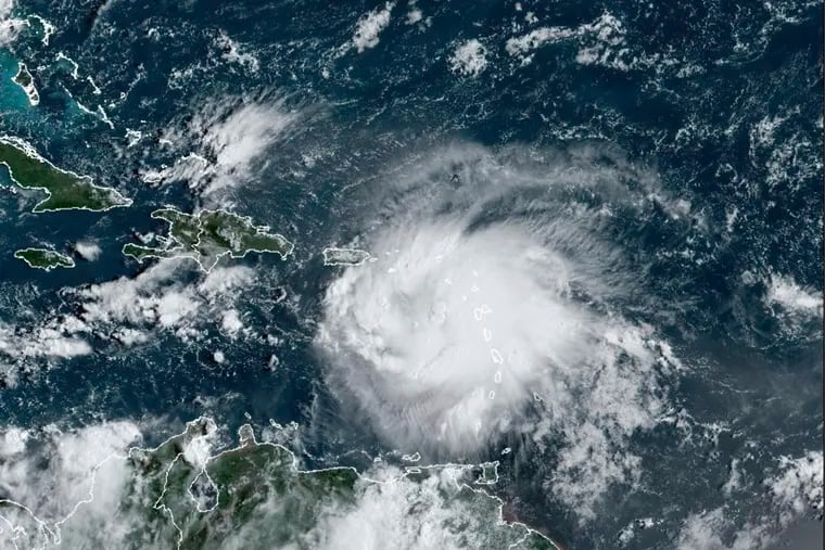 This satellite image provided by NOAA shows Tropical Storm Fiona in the Caribbean on Saturday, Sept. 17, 2022. 
 Fiona threatened to dump up to 16 inches (41 centimeters) of rain in parts of Puerto Rico on Saturday as forecasters placed the U.S. territory under a hurricane watch and people braced for potential landslides, severe flooding and power outages.