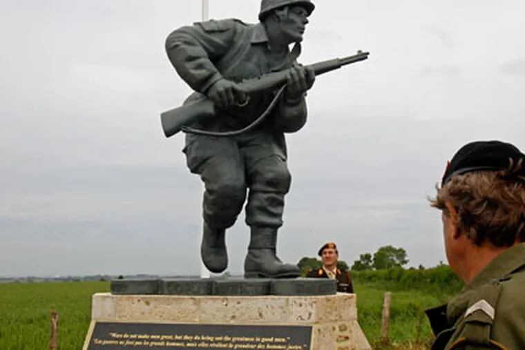 In this picture taken on Tuesday, June 5, 2012, shows the Colorado-made statue of Pennsylvania native Maj. Dick Winters, unveiled on Wednesday, June 6, 2012 near the beaches where the D-Day invasion of France began in 1944, one of many events marking the 68th anniversary of D-Day, the Allied operation that paved the way for the end of the war.  The bronze statue built near the village of Sainte Marie du Mont, is a  tribute to a man whose quiet leadership was chronicled in the book and television series "Band of Brothers." (AP Photo/Remy de la Mauviniere)
