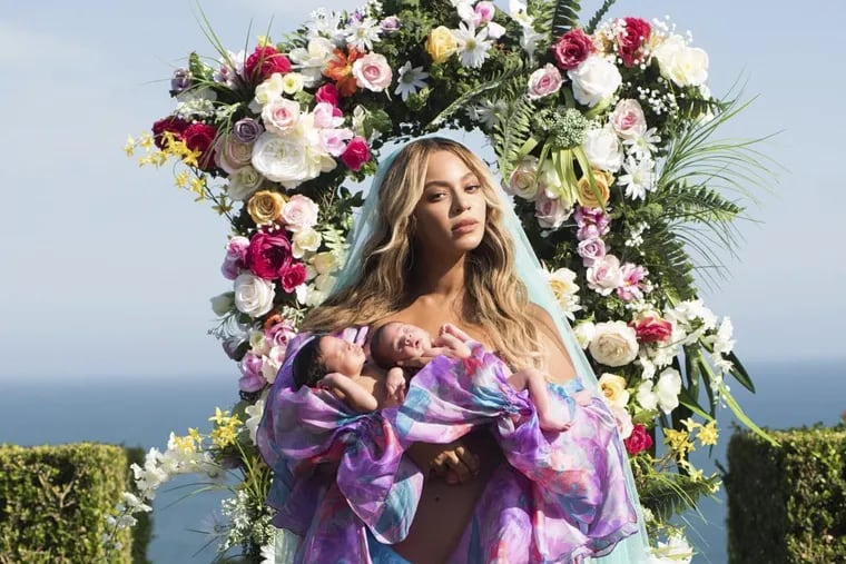 In this undated image released by Parkwood Entertainment on Friday, July 14, 2017, Beyonce posed with her newborn twins Sir Carter and Rumi. The singer posted the picture on Instagram late Thursday night and wrote in the caption, "Sir Carter and Rumi 1 month today."; She didn't mention the babies' genders, but Beyonce's mother wrote on Instagram that the pop star had given birth to a boy and a girl.