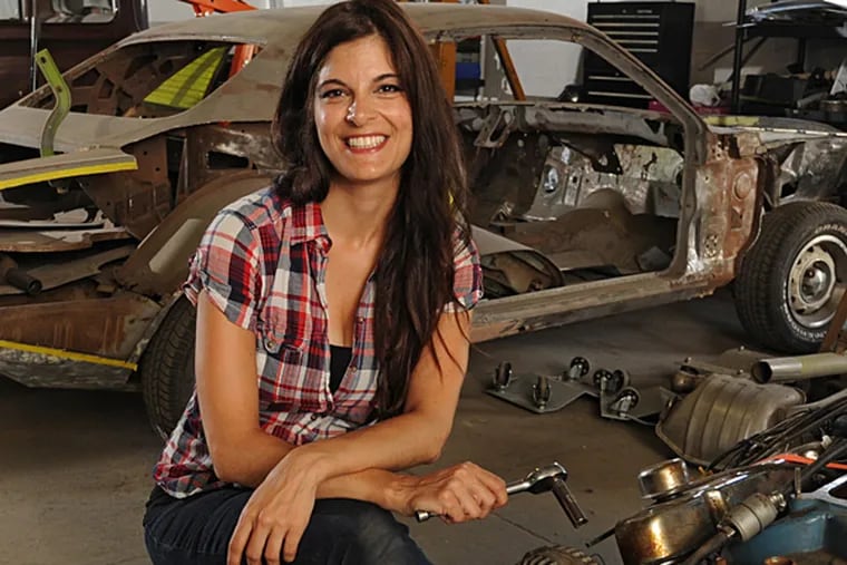 Rachel De Barros of Feasterville, a new addition to Velocity network's &quot;All Girls Garage,&quot; in the warehouse where she is restoring vintage vehicles.   ( CLEM MURRAY / Staff Photographer )