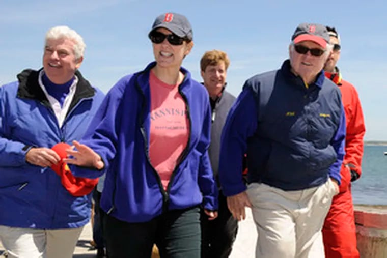 Sen. Edward Kennedy, right, with his wife, Victoria and Sen. Chris Dodd, walk the pier after leaving Kennedy&#0039;s sloop, Mya, after competing in the annual &quot;Figawi&quot; sailing race in Hyannisport yesterday.