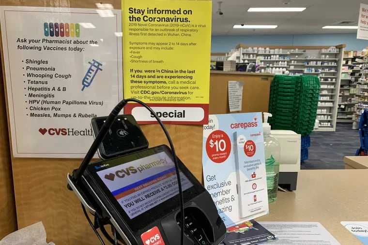 A sign with coronavirus information at the prescription counter of a CVS in Montgomery County, Pa.