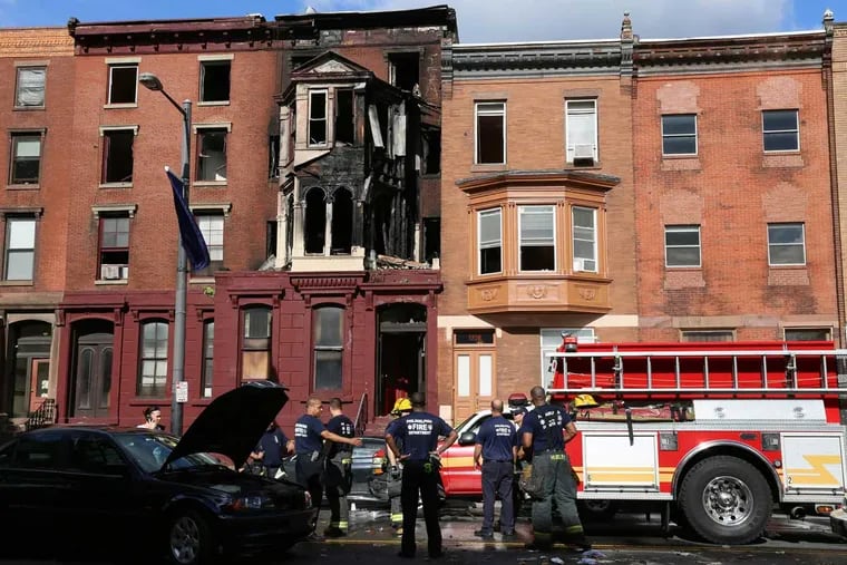 Fire crews investigate a fire on the 1300 block of South Broad Street in Philadelphia on Aug. 17, 2016.