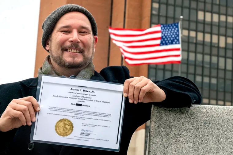 Marijuana activist Chris Goldstein poses on Independence Mall with a printed copy of his official pot pardon from President Joe Biden, which he received via email. Goldstein led monthly "Smoke Down Prohibition" protests on the site in 2012 and 2013 and was subsequently arrested for smoking weed on National Park Service grounds.