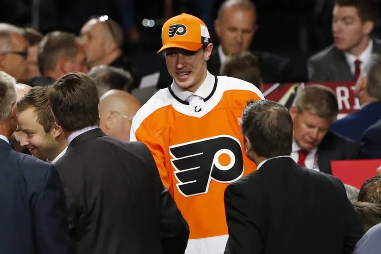 Isaac Ratcliffe talks with representatives from the Flyers after being selected in the second round of the NHL draft on Saturday. (AP Photo/Nam Y. Huh)