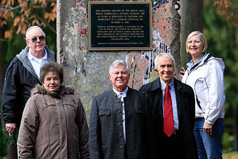 At a German club in Warminster, local German Americans (from left) William and Carol Ebinger, William Aust, Louis Oschmann, and Verna McDermott with the wall segment, which arrived in Philadelphia in 1990. (Akira Suwa / Staff)
