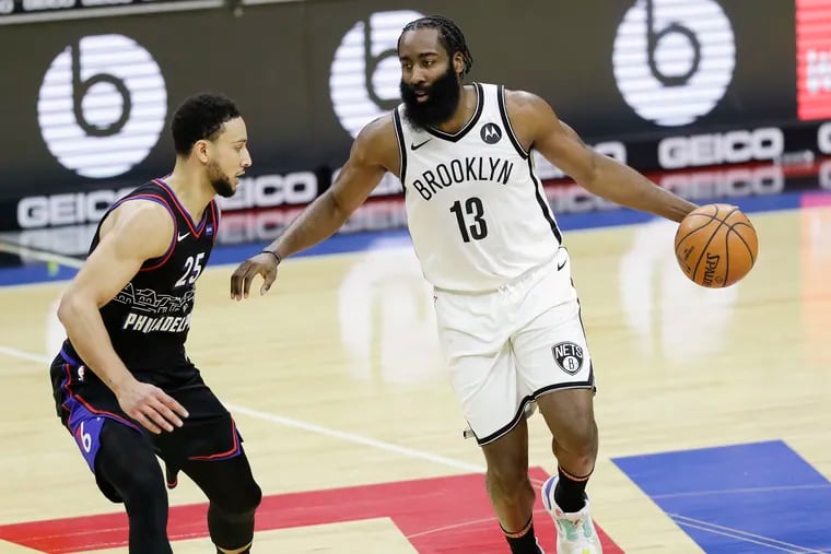 Brooklyn Nets guard James Harden dribbles the basketball against Sixers guard Ben Simmons on Saturday, February 6, 2021 in Philadelphia.
