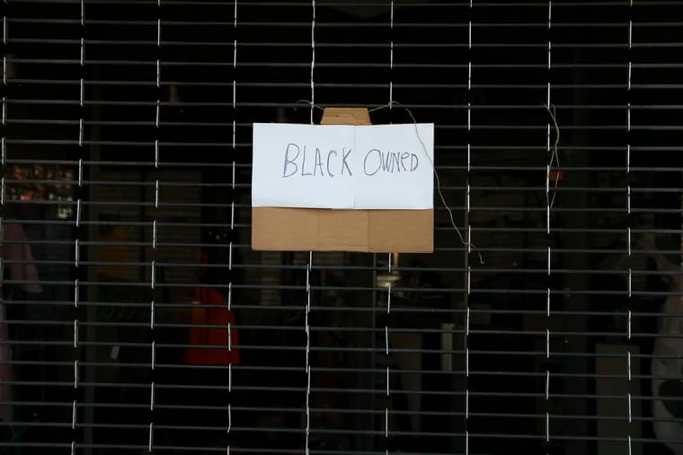 Signage reading "BLACK OWNED" hangs on a storefront in West Philadelphia before a verdict was announced in the trial of former Minneapolis police officer Derek Chauvin, who was charged with killing George Floyd, on Tuesday, April 20, 2021.