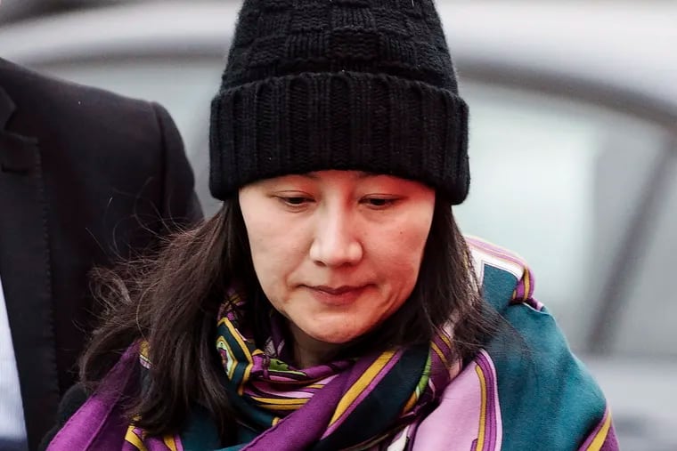 FILE - In this Dec. 12, 2018, file photo, Huawei chief financial officer Meng Wanzhou arrives at a parole office with a security guard in Vancouver, British Columbia. China on Tuesday, Jan. 22, 2019, demanded the U.S. drop a request that Canada extradite the top executive of the tech giant Huawei, shifting blame to Washington in a case that has severely damaged Beijing’s relations with Ottawa. (Darryl Dyck/The Canadian Press via AP, File)