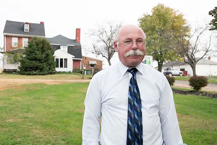 Pastor Vincent Kovlak in front of the Hugg-Harrison house, built in 1724, the oldest standing house in Bellmawr, Camden County, on October 29, 2014. (Jessica Griffin/Staff Photographer)