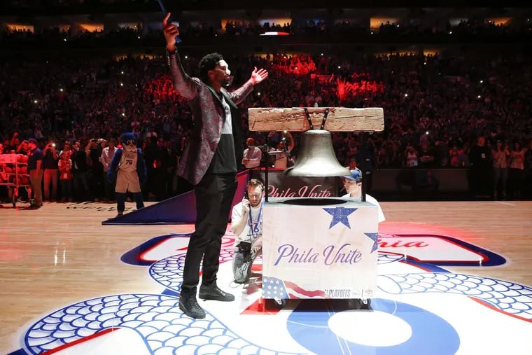 Sixers center Joel Embiid raises his arms while ringing the ceremonial Liberty Bell before the Sixers played Heat in the playoffs on Saturday.
