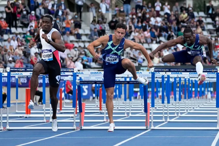 Devon Allen, center, runs in the men's 110 meters hurdles during the Meeting de Paris Diamond League athletics meet at Stade Charlety in Paris, in 2021.