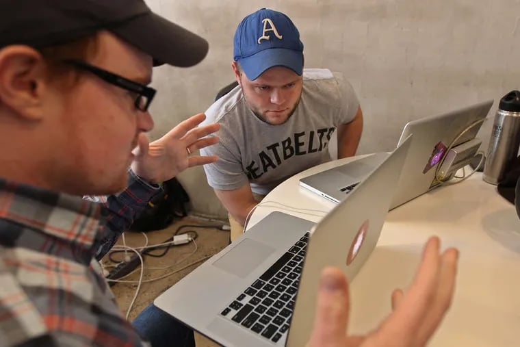 Kyle Fiedler (left) talks with Nat Lownes, his partner in the creation of a program to visualize starting lineups for all Major League Baseball teams using existing databases.