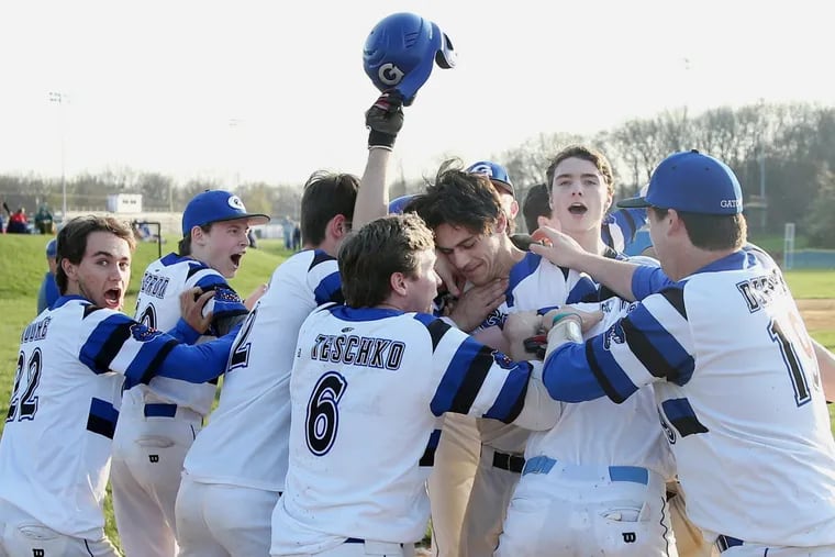 Gateway players mob Jackson Kelly, who had the game-winning grand slam against Haddon Township at Gateway Regional High School in Woodbury Heights, N.J., on Wednesday.