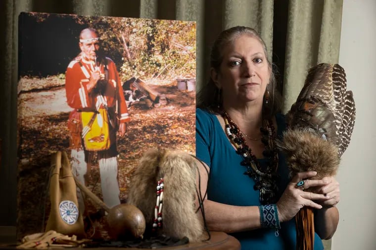 Ann Remy, who is Lenape, stands with her fan of wild turkey feathers.  The photo next to her is of her grandfather, Bill Thompson, also known as Chief Whipoorwill, at the Churchville Nature Center.  At the base of the photo is his medicine bag, a rattle passed down through the family, and Ann's beaver fur purse.