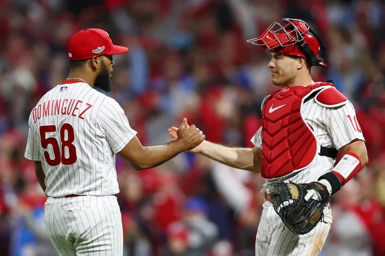 Seranthony Dominguez of the Philadelphia Phillies celebrates with J.T. Realmuto defeating the San Diego Padres 4-2 in game three of the National League Championship Series at Citizens Bank Park on October 21, 2022 in Philadelphia, Pennsylvania. (Photo by Elsa/Getty Images)