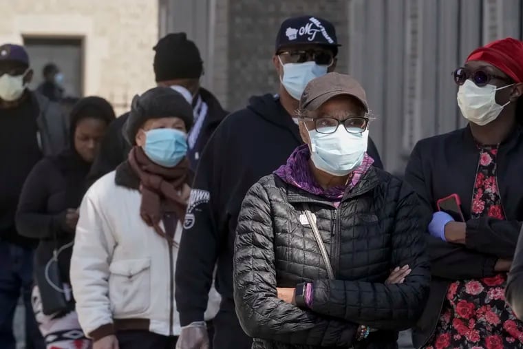 Wisconsin's April 7 election was one of the first of the coronavirus era, with long lines of face-mask-clad voters. Philadelphia could see the same on June 2. Here, voters wait in line to cast ballots in Milwaukee in April.