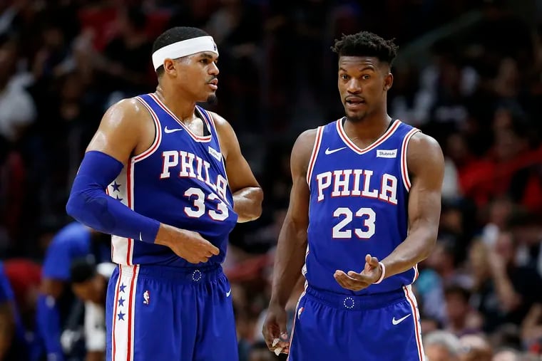 Former 76ers teammates Jimmy Butler (23) and Tobias Harris discussing strategy in 2019.