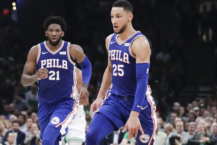 Sixers guard Ben Simmons dribbles the basketball on a fast break with center Joel Embiid against the Boston Celtics on Tuesday, October 16, 2018 in Boston.