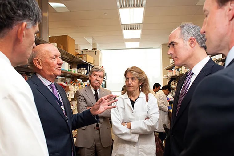 Senator Bob Casey tours the Penn Cardiovascular Institute's research lab at HUP's Perelman Pavilion on Wednesday October 23, 2013.  Left to right, Dr. Daniel Rader, professor and chief of the division of translational medicine, Ralph Muller, CEO of UPHS, Dr. Peter Quinn Dr. Jean Bennett, professor of Ophthalmology, Sen. Casey , Dean Larry Jameson, Dean of the Perelman School of Medicine.( Ed Hille / Staff Photographer)