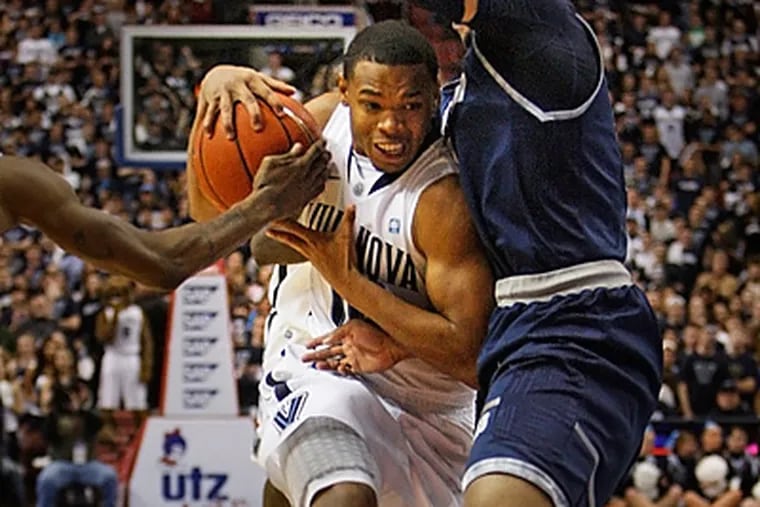 Villaova's Corey Fisher tries to drive between two Georgetown defenders. (Ron Cortes/Staff Photographer)