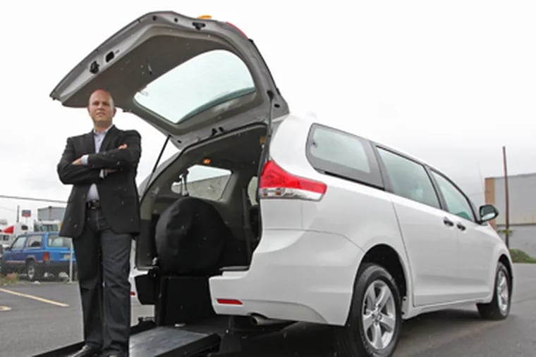 Everett Abitbol stands on the manual ramp that opens out from the back of this minivan and will allow handicapped passengers to be able to use a handicap-accessible taxi for the first time in Philadelphia. (Michael Bryant / Staff photographer)