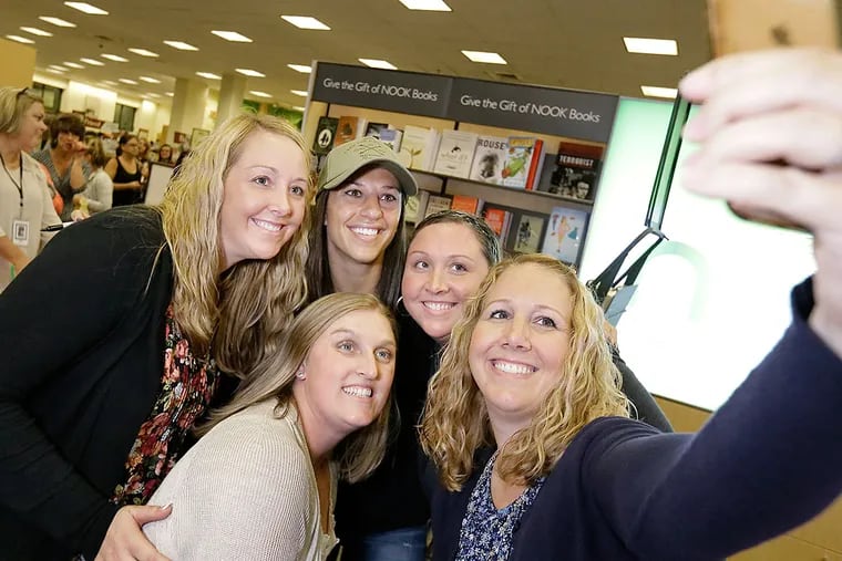 From left to right, Kacy Padura of East Greenwich, Maureen Carvelli of East Greenwich, Carli Lloyd, Kristi Zemski of Wash Township and Jennifer Matthews of East Greenwich takes the photo during Lloyd's appearance at Barnes and Noble in Cherry Hill, N.J.