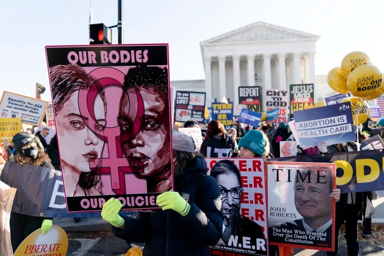 Advocates demonstrate in front of the U.S. Supreme Court Wednesday, Dec. 1, 2021, in Washington, as the court hears arguments in a case from Mississippi, where a 2018 law would ban abortions after 15 weeks of pregnancy, well before viability.