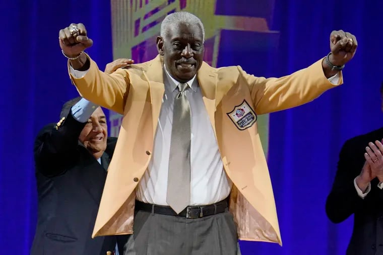 Harold Carmichael, who was enshrined in the Pro Football Hall of Fame Saturday after a three-decade-plus wait, shows off his gold HOF jacket.