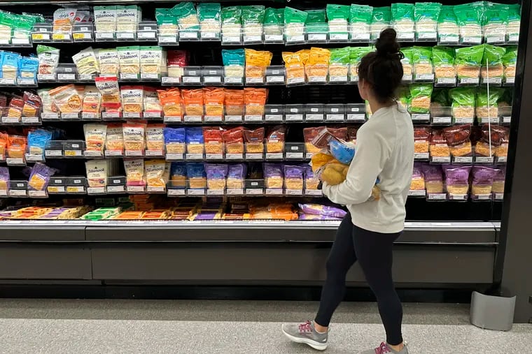 A shopper peruses the refrigerated offerings in a Target store in Sheridan, Colo.