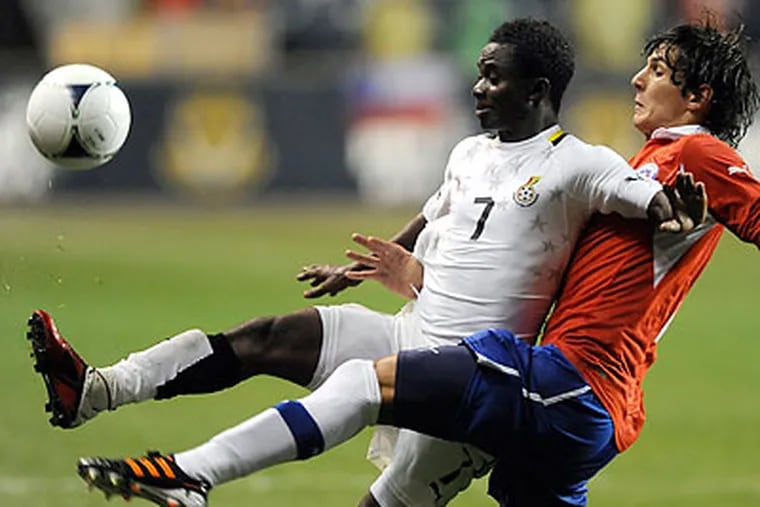 Ghana's Richard Mpong beats Chile's Lucas Dominguez to the ball during the second half. (Michael Perez/AP)