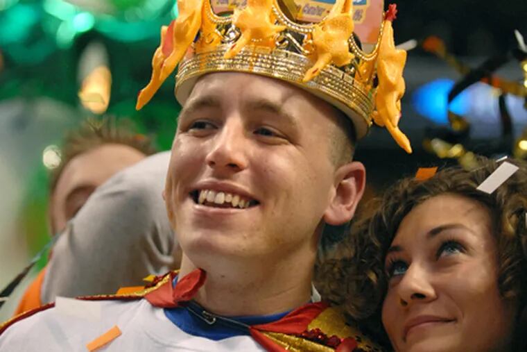 Joey Chestnut celebrates his win at last year's Wing Bowl with a supporter. The odds-on favorite to retain his crown, he will be challenged by five-time champion Bill "El Wingador" Simmons.