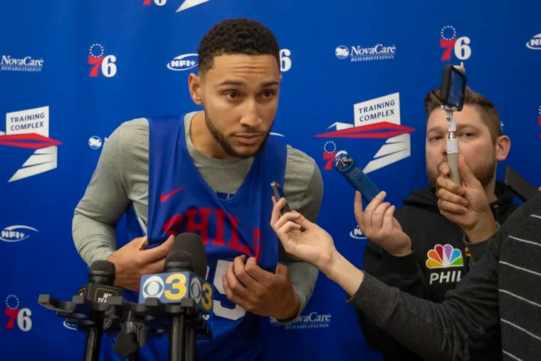 Sixers guard Ben Simmons leans forward to hear a question after Sixers practice at their training facility in Camden on Wednesday.