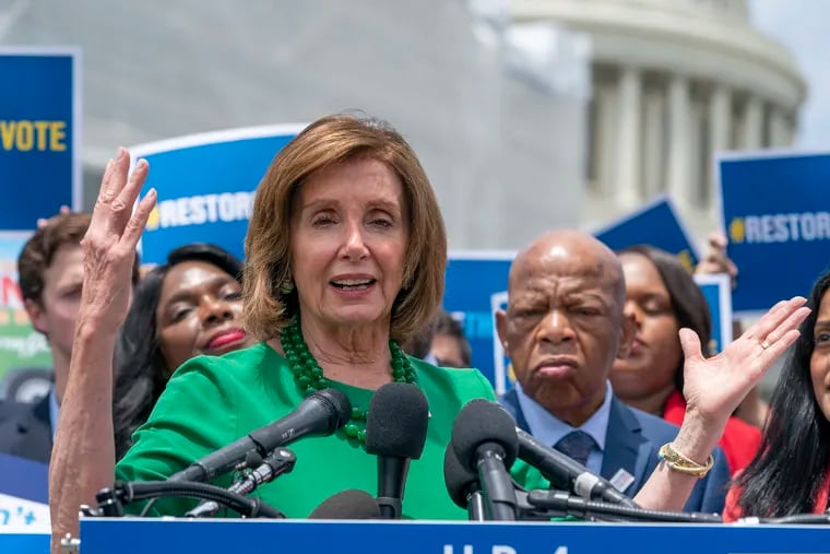 Speaker of the House Nancy Pelosi (D., Calif.), flanked by Rep. Terri Sewell (D., Ala.) and Rep. John Lewis (D., Ga.), talks to reporters about the need for the Voting Rights Advancement Act of 2019, at the Capitol in Washington, Tuesday, June 25, 2019.