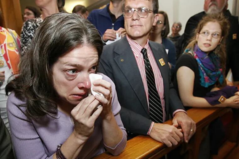 Mimi Copp wipes a tear from her eye after a prayer at the United Methodist Church on May 26. Copp and eleven others were acquitted of charges stemming from a protest in front of Colosimo's gun shop. (Alejandro A. Alvarez / Staff Photographer)