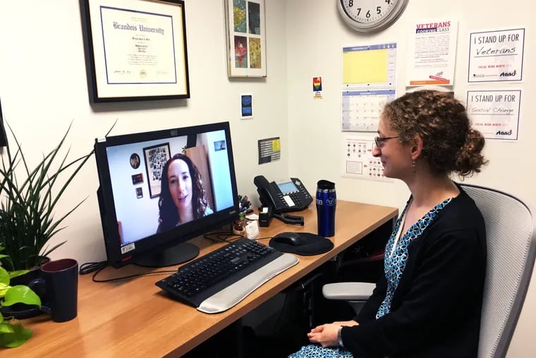 Therapist Mattea Lewitt conducts a therapy session via streaming video in the Steven A. Cohen Military Family Clinic at Penn Medicine.