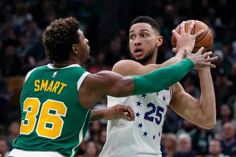 Boston's Marcus Smart (36) defends against Ben Simmons (25) during the second half of the Sixers' 121-114 overtime loss to the Celtics Tuesday. Simmons finished with 11 points, 14 rebounds and eight assists. (Michael Dwyer / AP Photo)