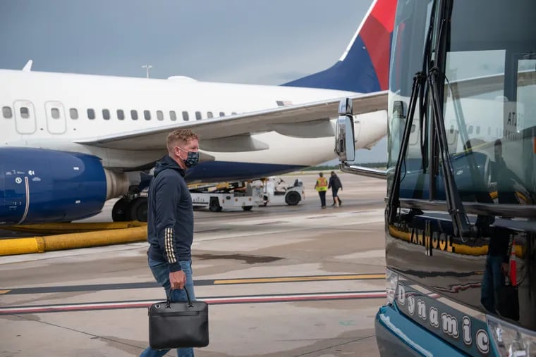 Union manager Jim Curtin walking to the bus after the team's charter flight landed in Orlando on Thursday.