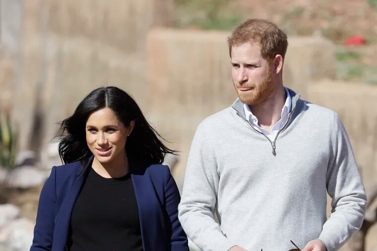 Britain's Prince Harry and Meghan, Duchess of Sussex, with her hand displaying a henna tattoo during a visit to an 'Education for All' boarding house in Asni Town in Morocco, Sunday, Feb. 24, 2019. The Duke and Duchess of Sussex are on a three day visit to the country. (AP Photo/Kirsty Wigglesworth)