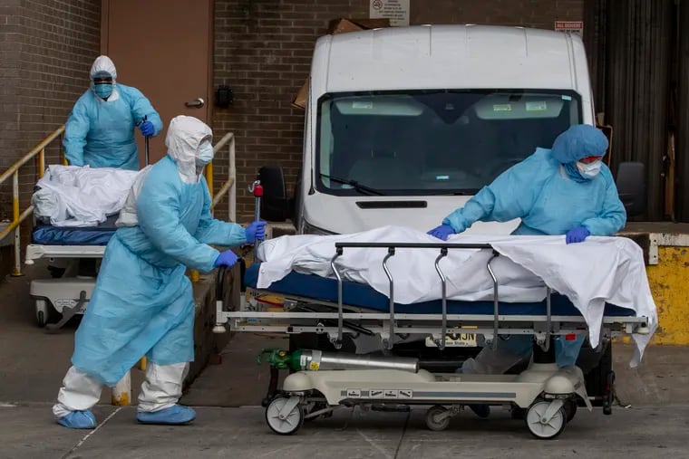 Medical personnel remove bodies from the Wyckoff Heights Medical Center on April 2, 2020 in the Brooklyn borough of New York, where the coronavirus pandemic has overwhelmed hospitals.