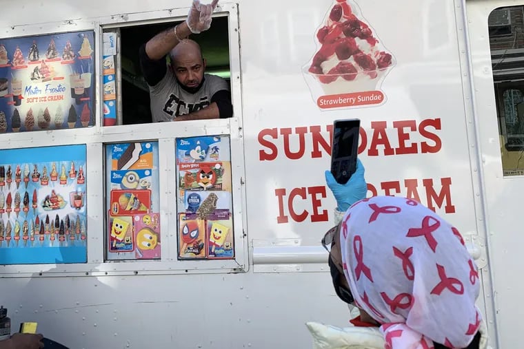 Fairhill activist Asteria Vives (right) argues with the driver of an ice cream truck in the neighborhood. Vives recorded the encounter, as she does with other ice cream purveyors.
