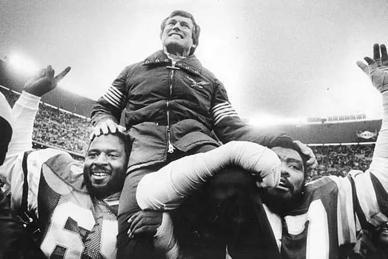 Eagles Charlie Johnson (65) and Claude Humphrey carrying Dick Vermeil after a win against the Vikings.
