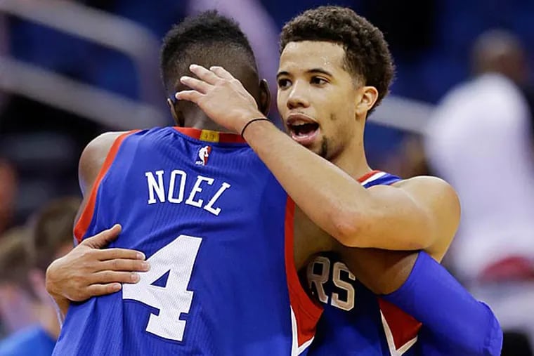 Philadelphia 76ers' Nerlens Noel (4) and Michael Carter-Williams congratulate each other after defeating the Orlando Magic 96-88 in an
NBA basketball game, Sunday, Dec. 21, 2014, in Orlando, Fla. (John Raoux/AP)