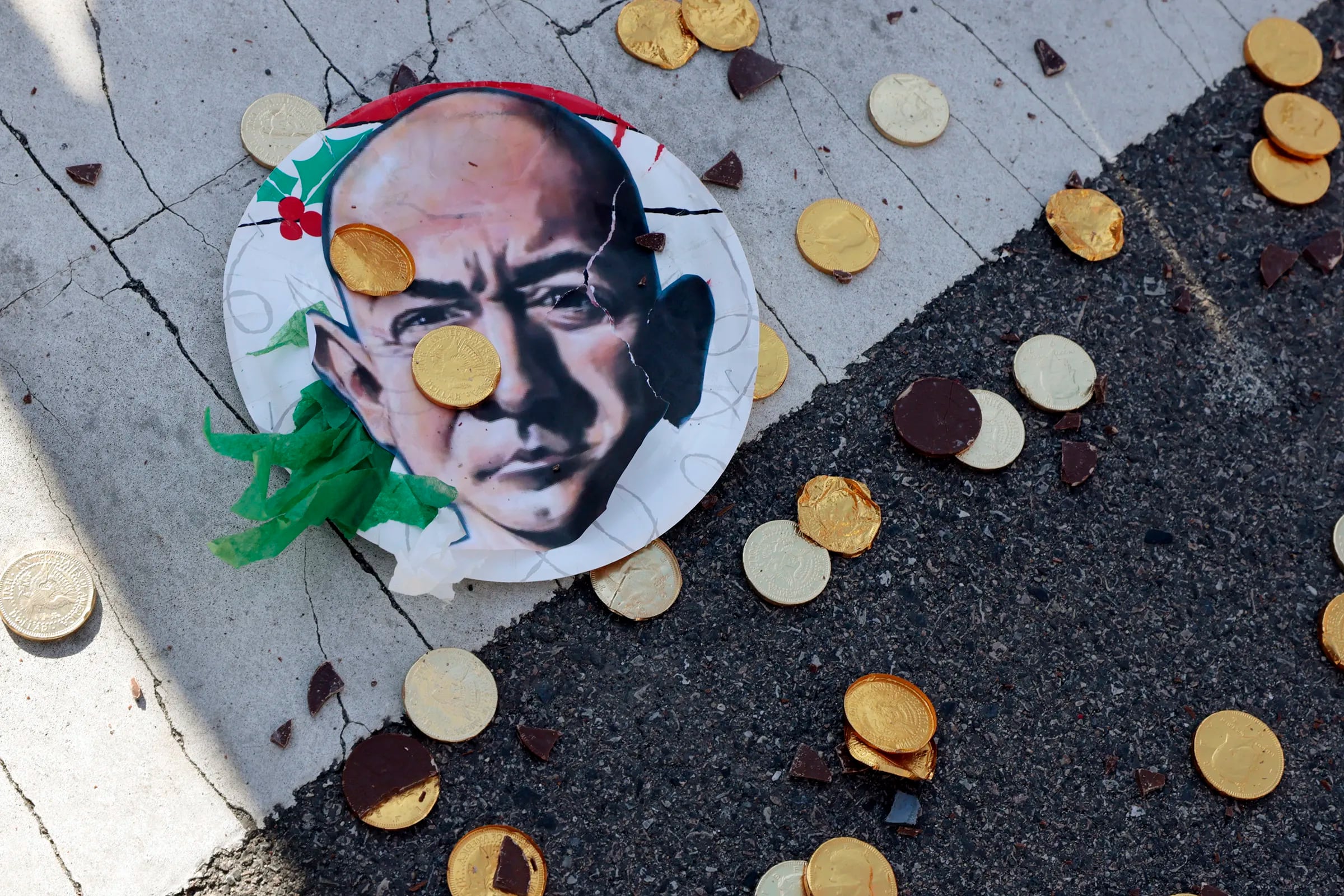 A ripped Jeff Bezos photo and milk chocolate coins from a piñata of Bezos that was smashed during a march and rally in Philadelphia last month.