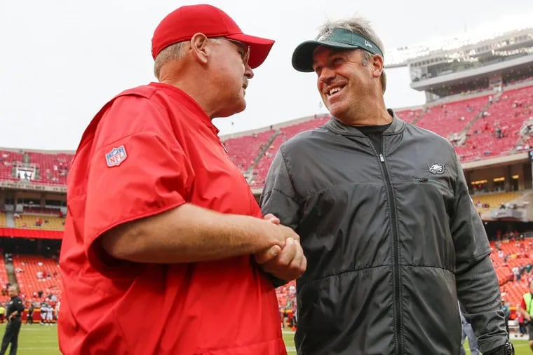 Eagles coach Doug Pederson meets with Chiefs coach and former Eagles coach Andy Reid during pregame warm-ups before the Eagles played the Chiefs on Sunday, September 17, 2017 in Kansas City, Mo.