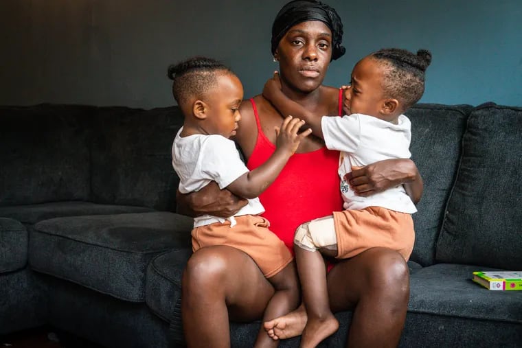 Octavia Brown with her twin sons Jy-Fir, left, and By-Kir, right, on Wednesday.