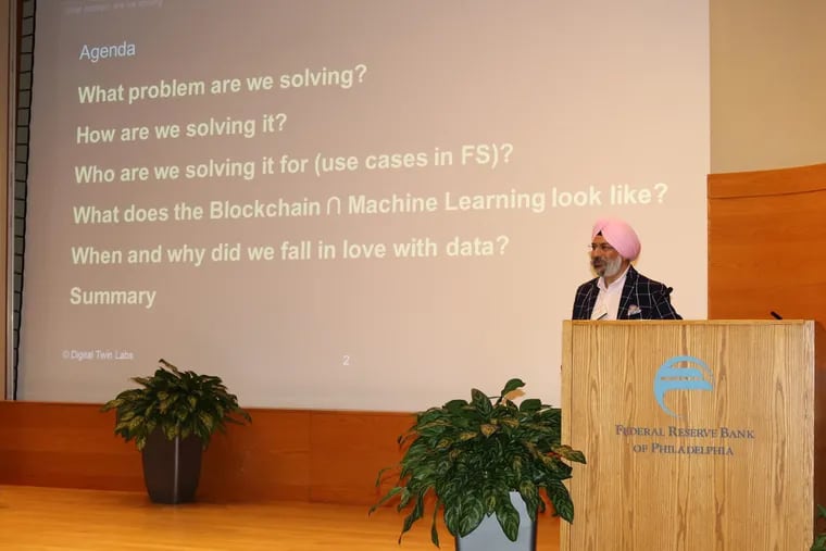 Gurvinder Ahluwalia, a former IBM executive who founded and runs Digital Twin Labs, LLC, lectures to Philadelphia Federal Reserve officials and guests about fintech decision making and blockchain at a conference in 2017