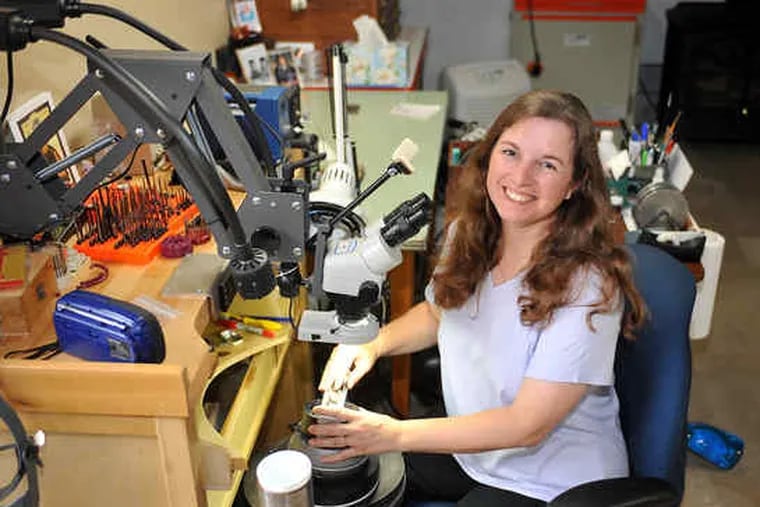 Tira Mitchell at her engraving workstation in the basement of her Bucks County home. She's gained a reputation for taking on tough projects.
